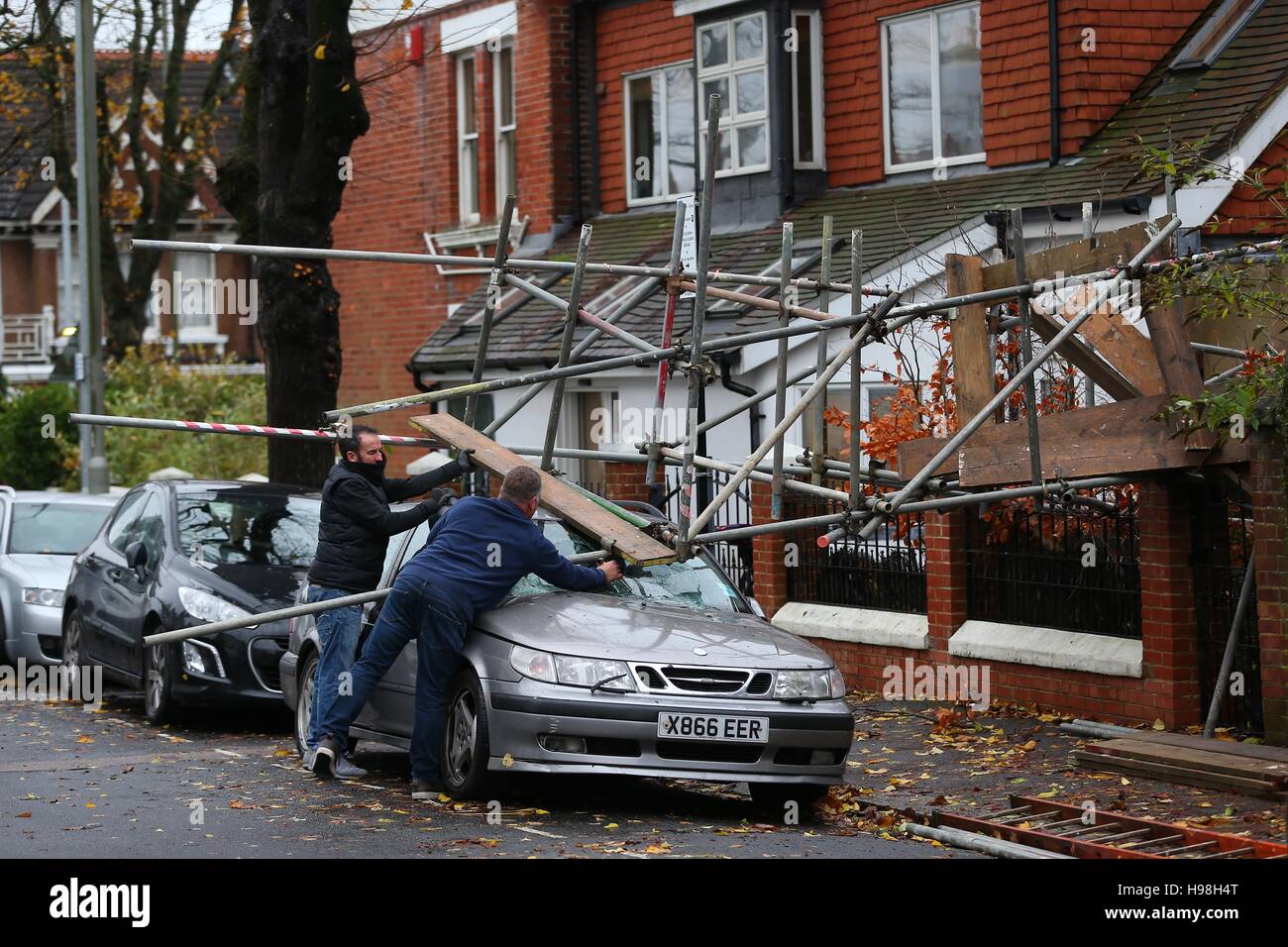 Workmen dismantle scaffolding after it collapsed onto a car during storms and high winds overnight in Brighton, East Sussex. Stock Photo