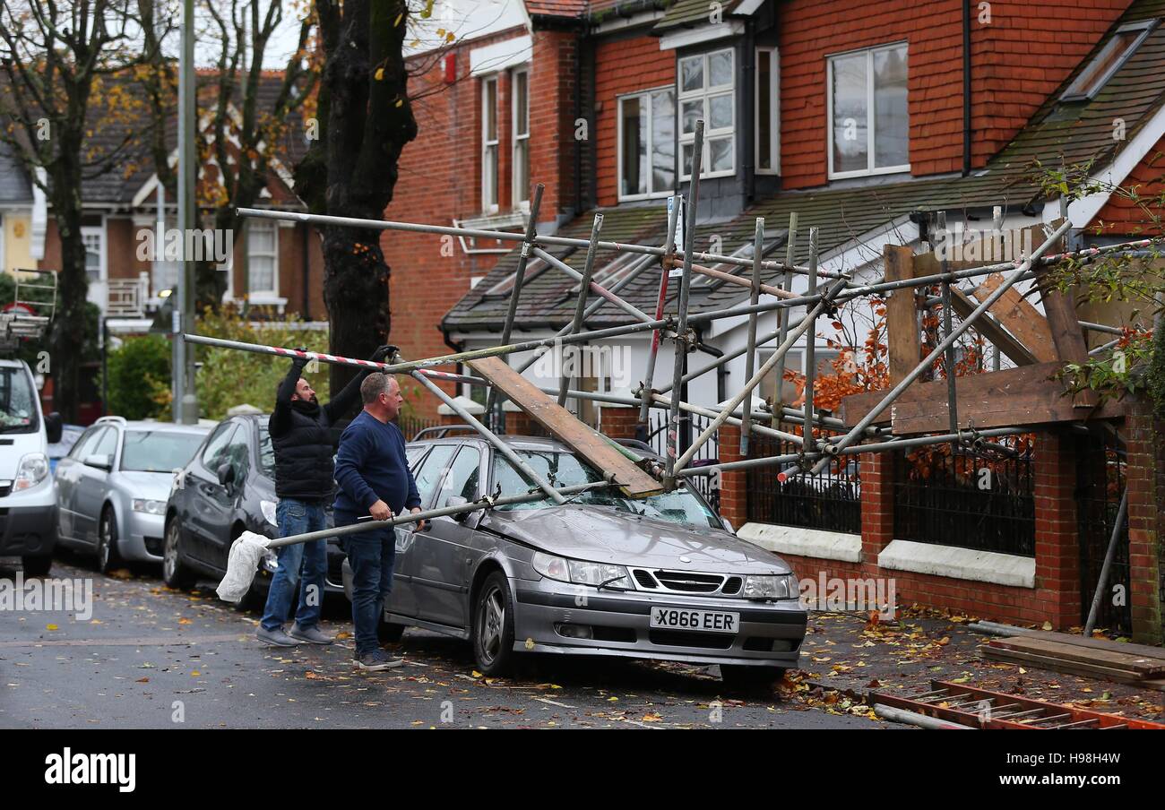 Workmen dismantle scaffolding after it collapsed onto a car during storms and high winds overnight in Brighton, East Sussex. Stock Photo