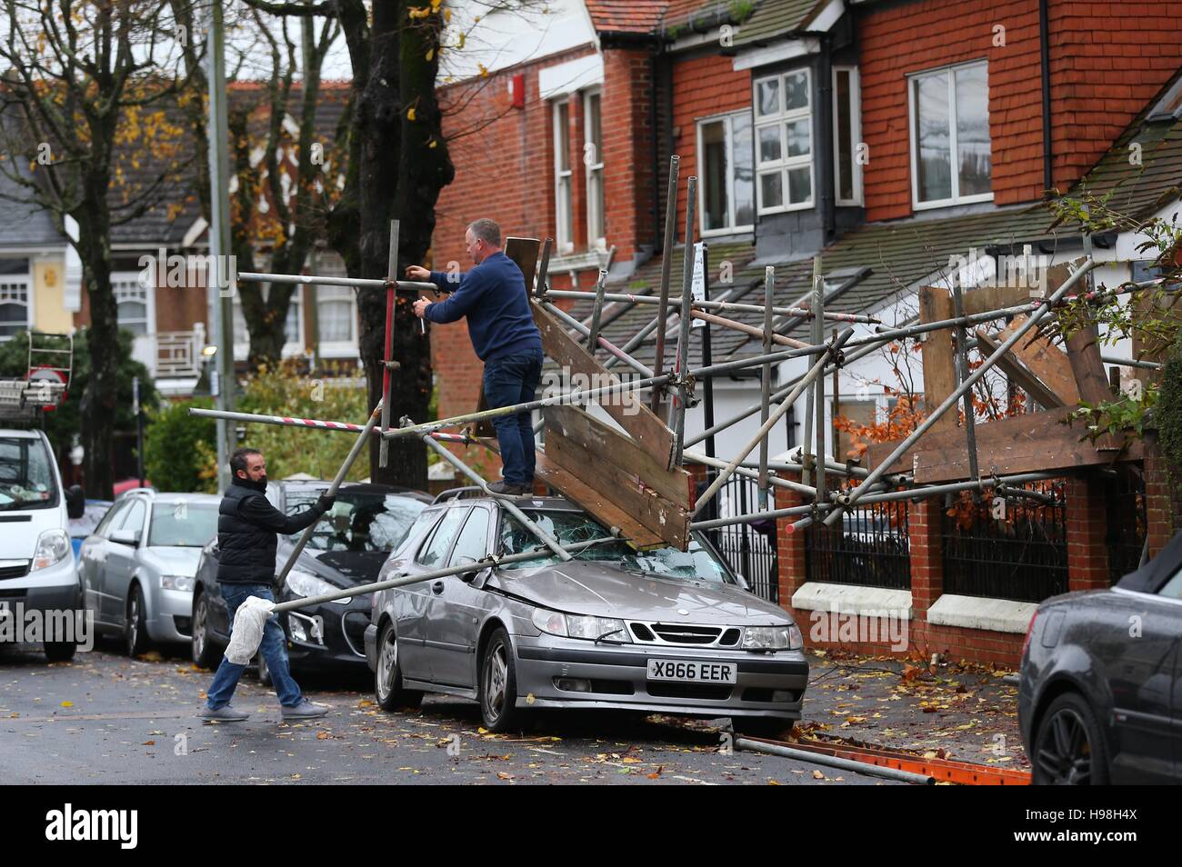 Workmen dismantle scaffolding after it collapsed onto a car during storms and high winds overnight in Brighton, East Sussex. Stock Photo