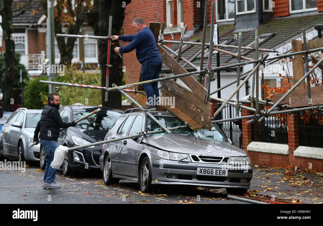 Workmen dismantle scaffolding after it collapsed onto a car during storms and high winds overnight in Brighton, East Sussex. Stock Photo