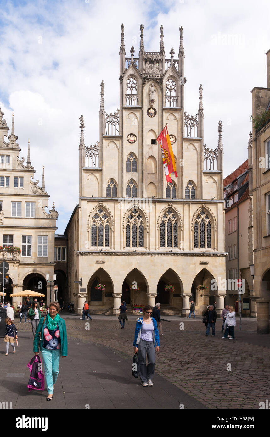 People walking before the old town hall or Rathaus in Munster, Germanty, Europe Stock Photo