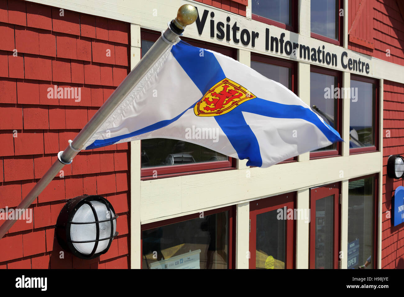 A Nova Scotian flag flies outside of the Visitor Information Centre in the  fishing village of Peggy's Cove in Nova Scotia, Canada. The fishing village  Stock Photo - Alamy