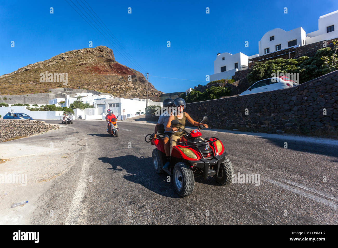 Road to Oia, rental quad bike, tourists, Santorini, Greek Islands, Cyclades, Greece Stock Photo