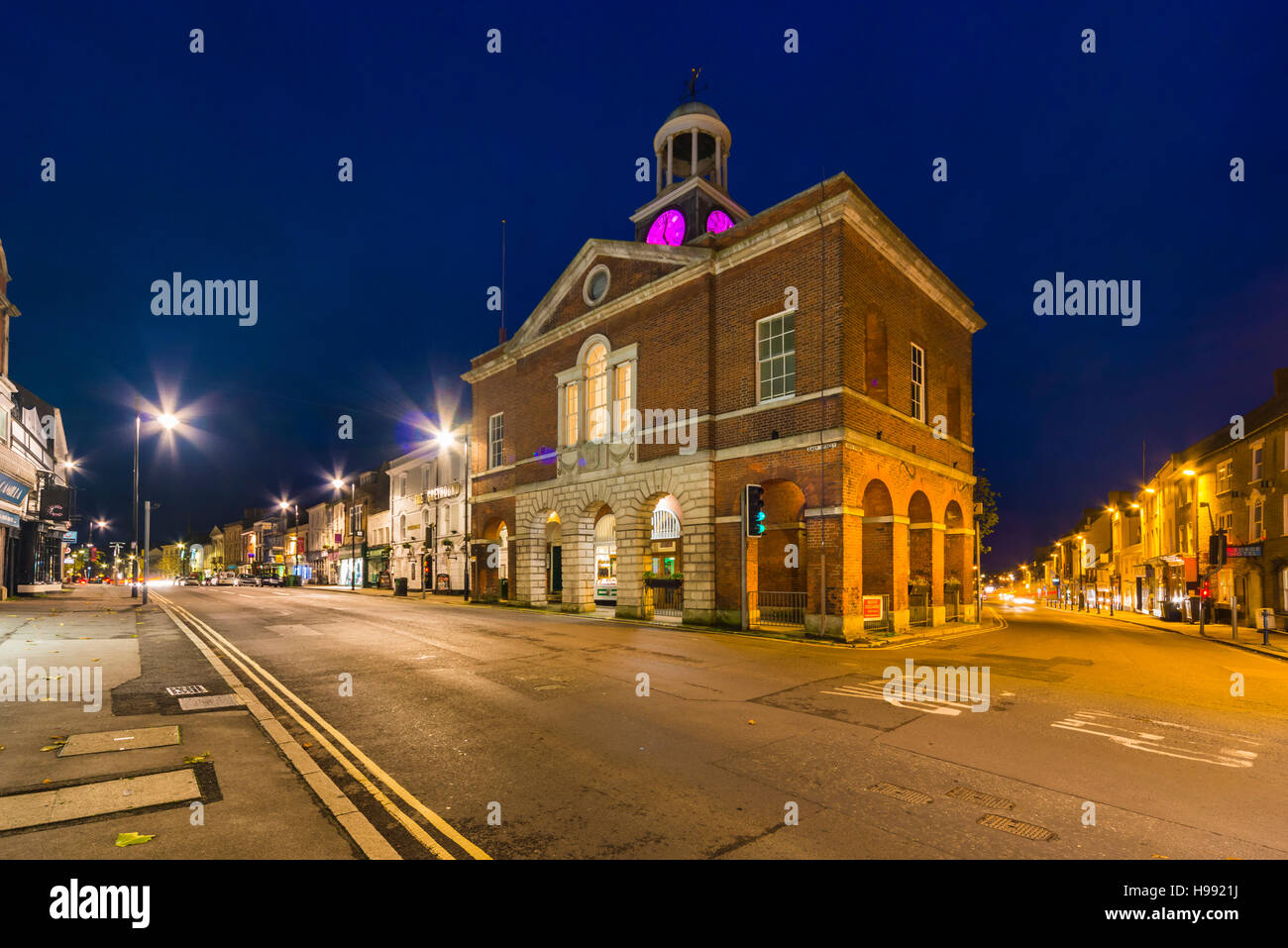 Bridport, Dorset, UK.  20th November 2016.  UK Weather.  A view at dusk of the Town Hall in Bridport in Dorset which is located at the junctions of East Street, West Street and South Street, sits under a darkening cloudy sky.  Bridport is an historic market town which still has a year round market on the streets every week on Wednesdays and Saturdays.  Picture: Graham Hunt/Alamy Live News Stock Photo