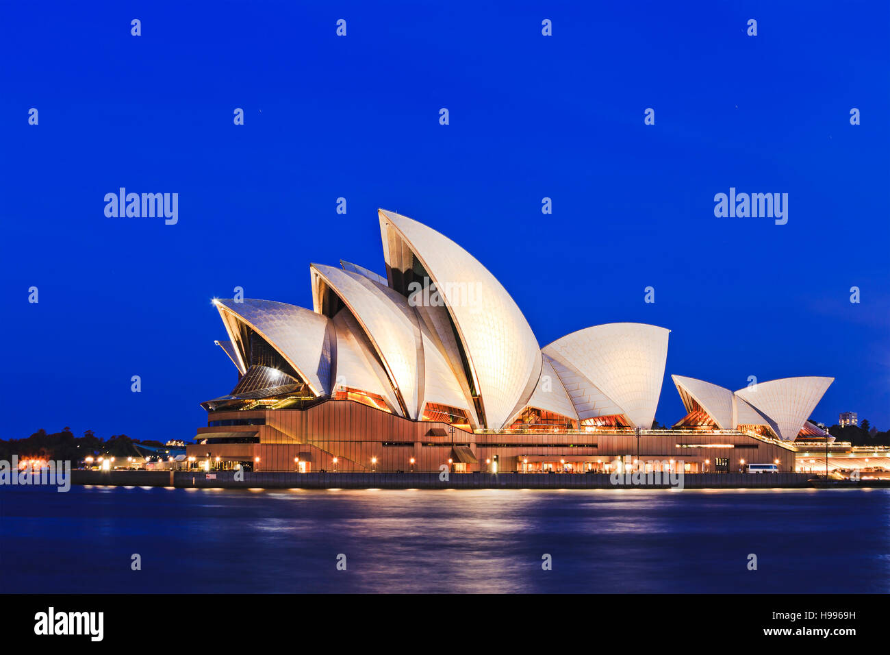 Sydney, Australia - 15 November 2016: Iconic worlds' buildings - Sydney Opera house in full glory at sunset brightly illuminated Stock Photo