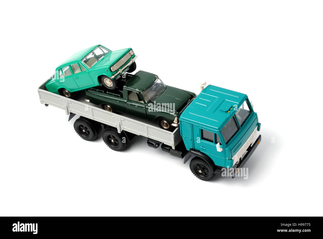 Toy cars in the back of toy truck on a white background Stock Photo