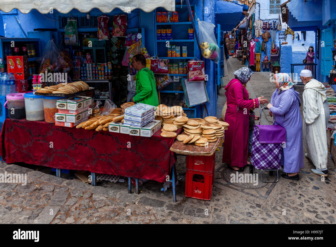 Local Women Buying Food In The Medina, Chefchaouen, Morocco Stock Photo