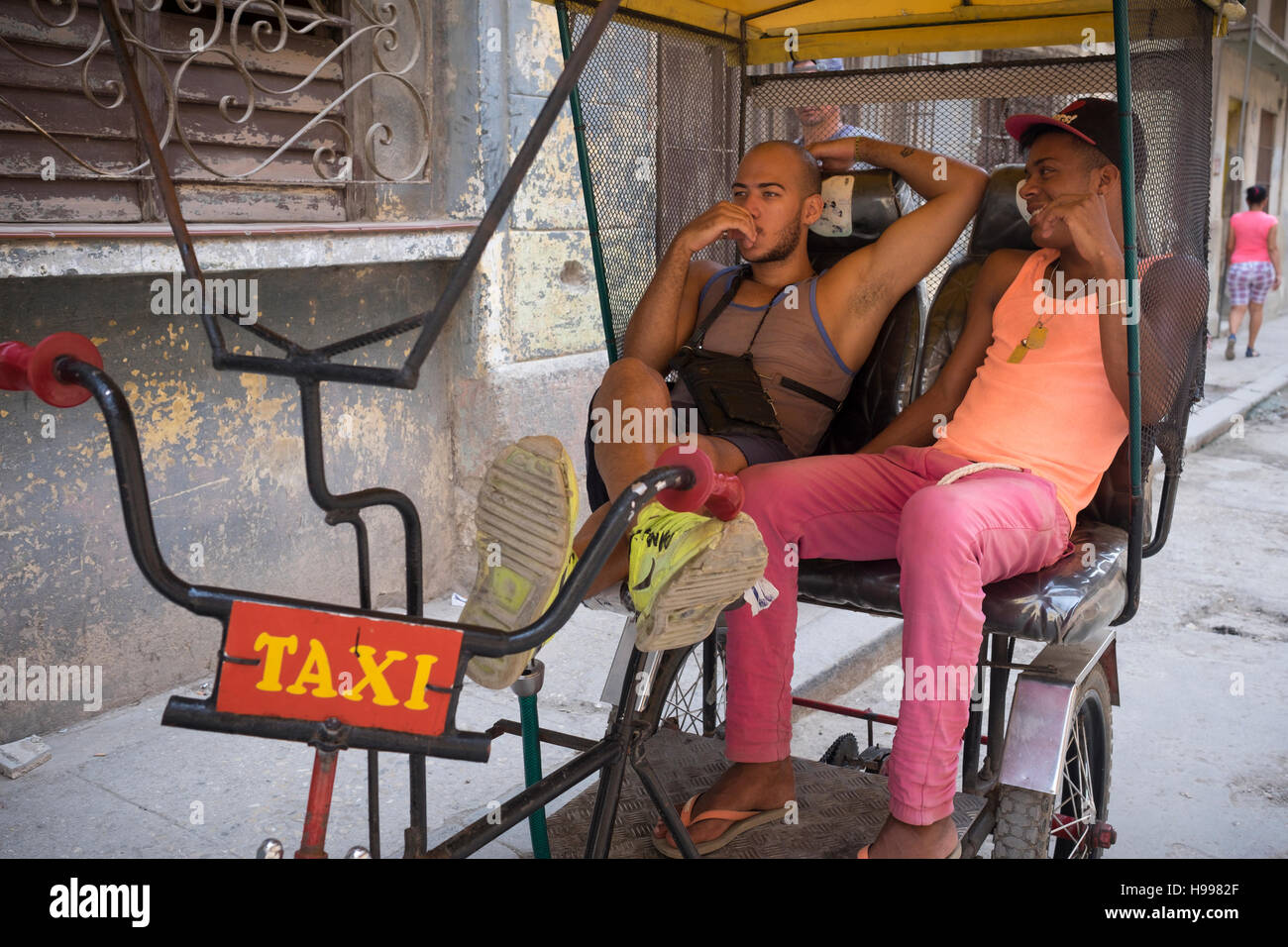 Havana, Cuba: Bicitaxi in a street scene, Old Havana Stock Photo