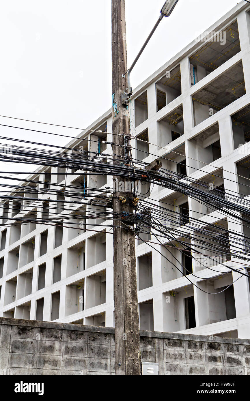 chaotic wires on electricity post Stock Photo