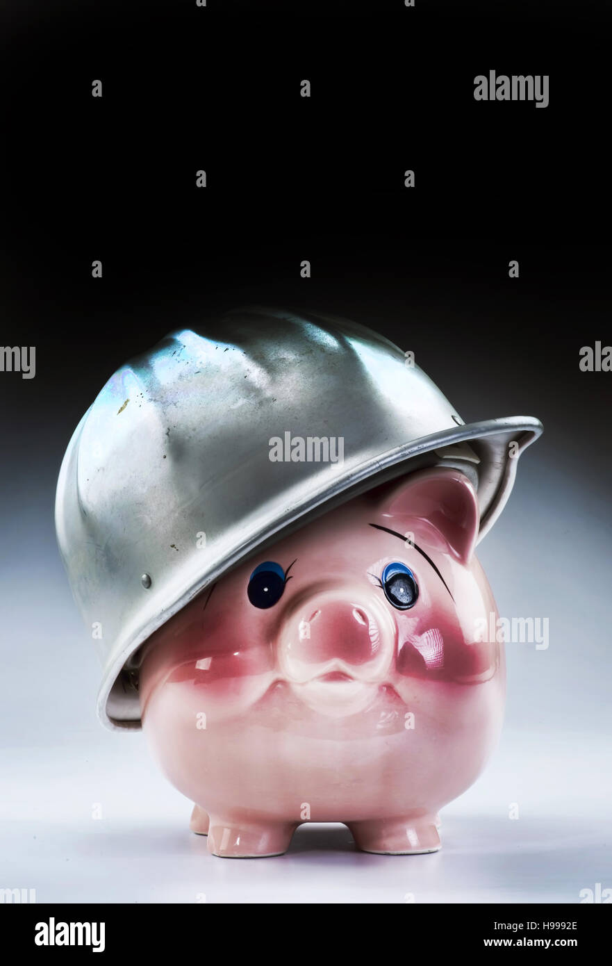 Hard hat piggy at work with room for your type. Stock Photo