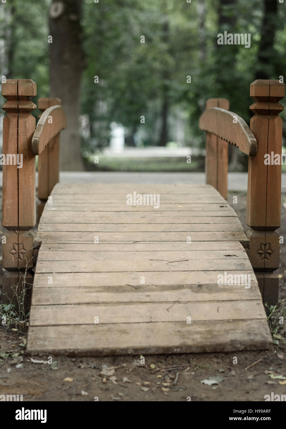 wooden bridge in Park on a background of green grass Stock Photo