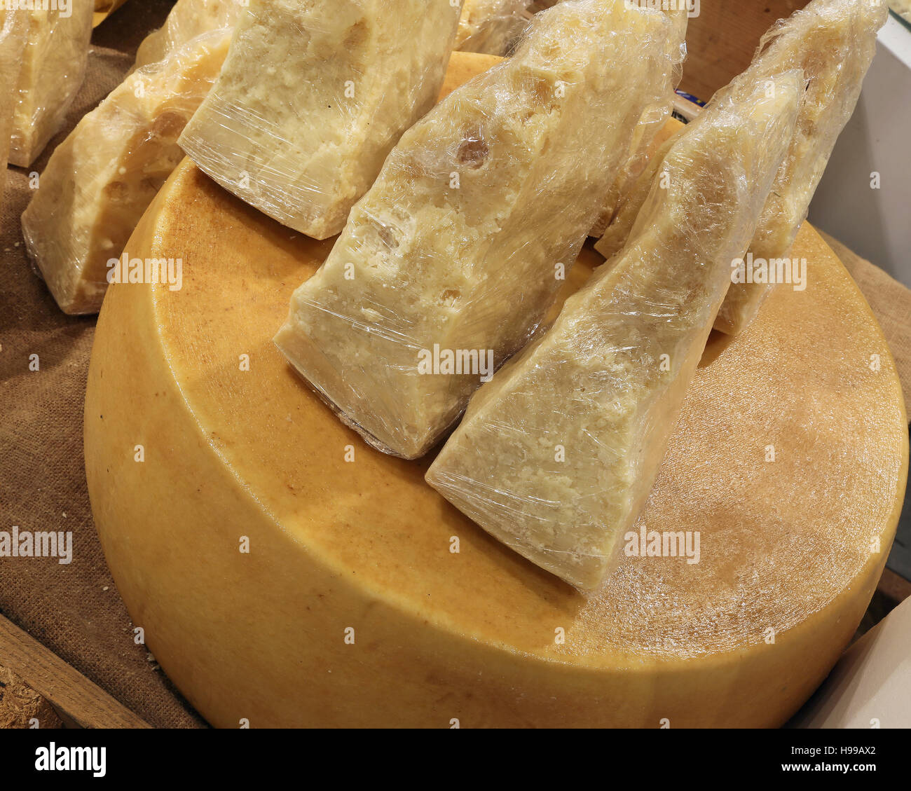 many pieces Italian Parmesan cheese for sale in the dairy Stock Photo
