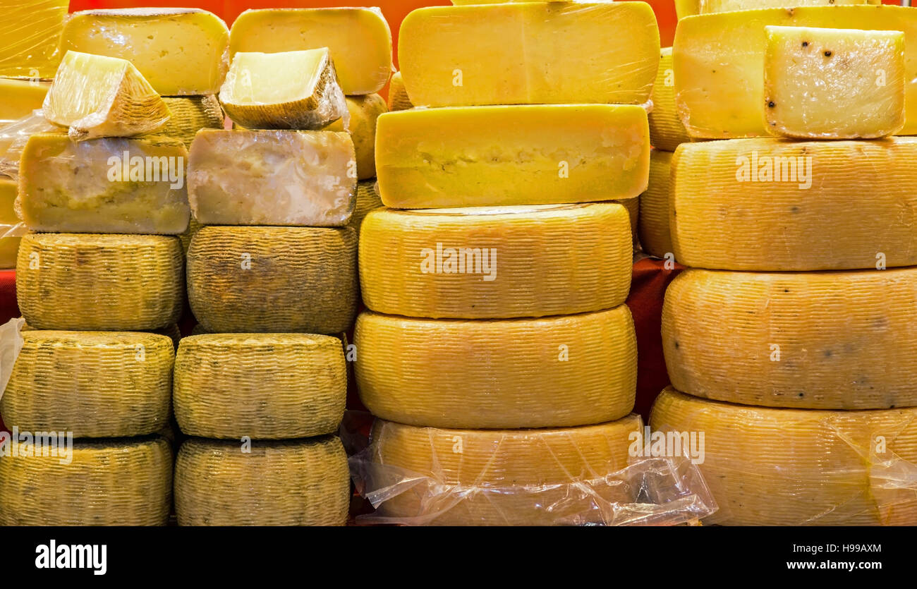 aged and fresh cheeses on sale in the Italian stand of typical foods Stock Photo