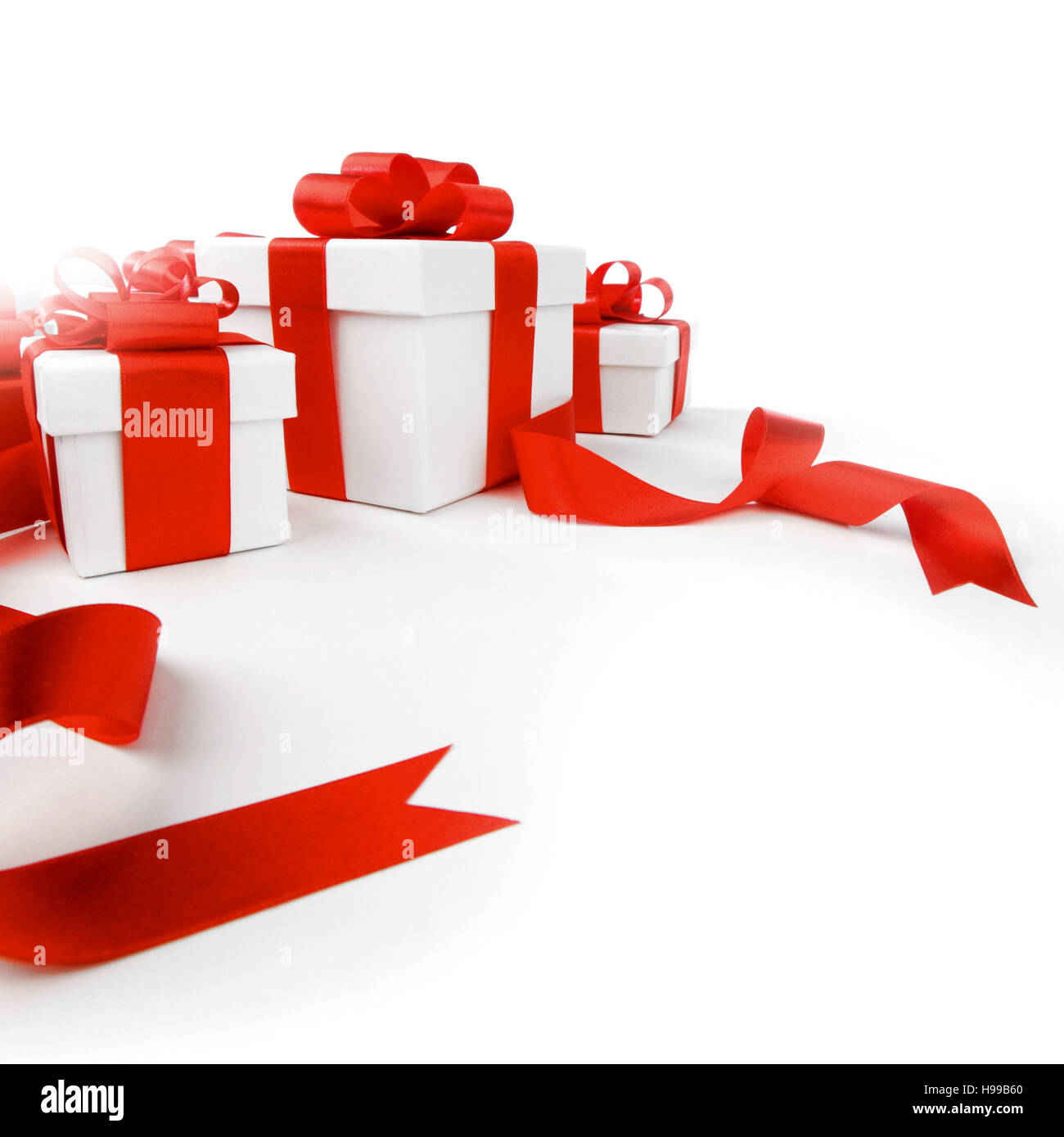 White gift boxes with red ribbon bows isolated on white background