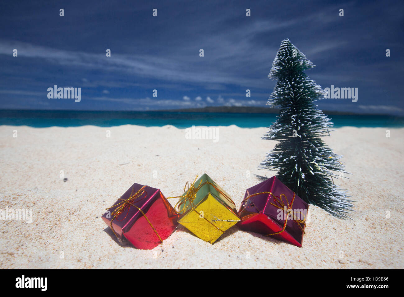 Christmas gifts on the sand of tropical sea beach Stock Photo