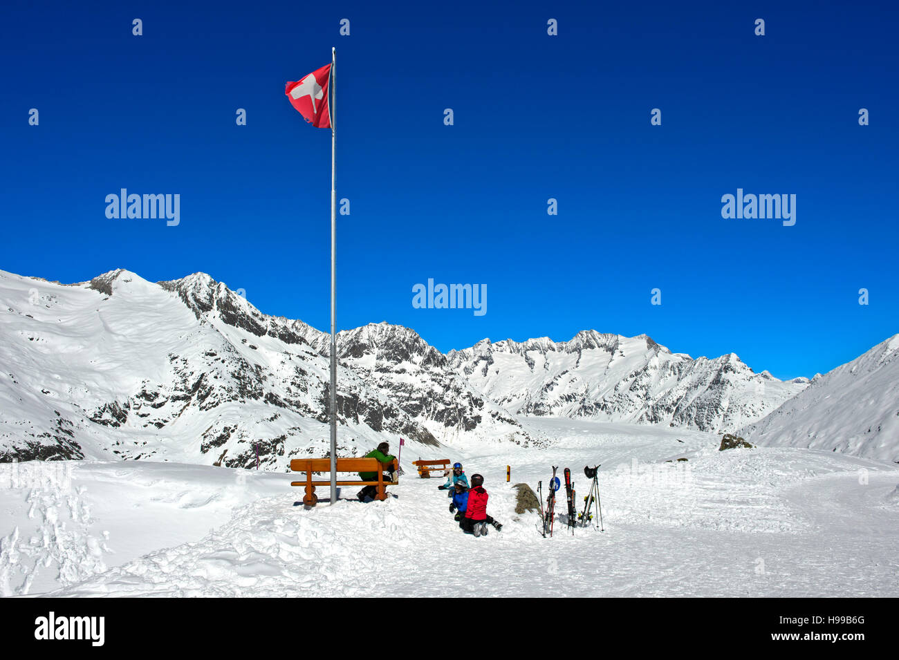 Swiss flag at the viewpoint Moosfluh in the Aletsch Glacier region, Riederalp, Valais, Switzerland Stock Photo