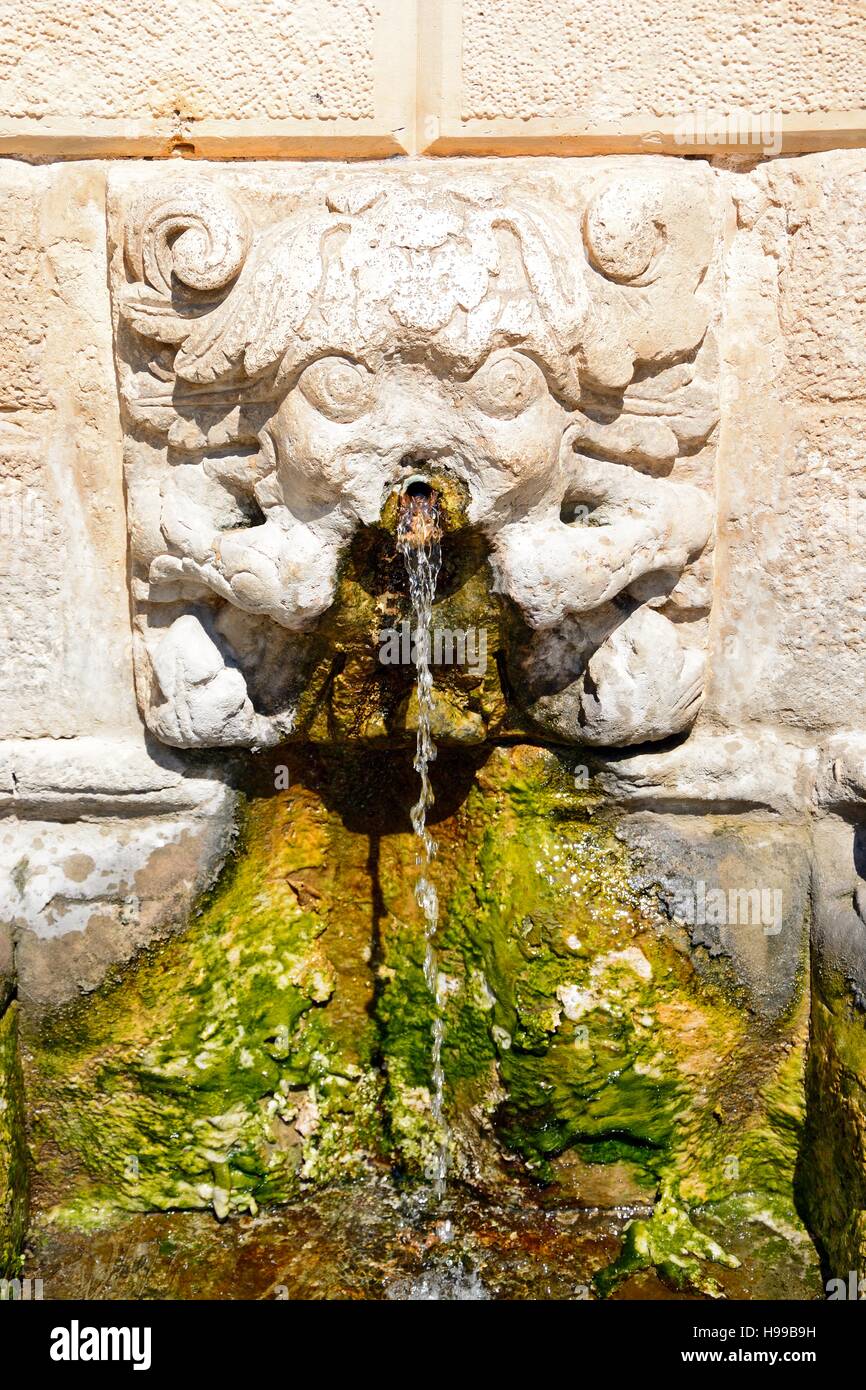 Close up of the lions head water spouts in the Venetian Rimondi fountain in Petychaki square, Rethymno, Crete, Greece, Europe. Stock Photo