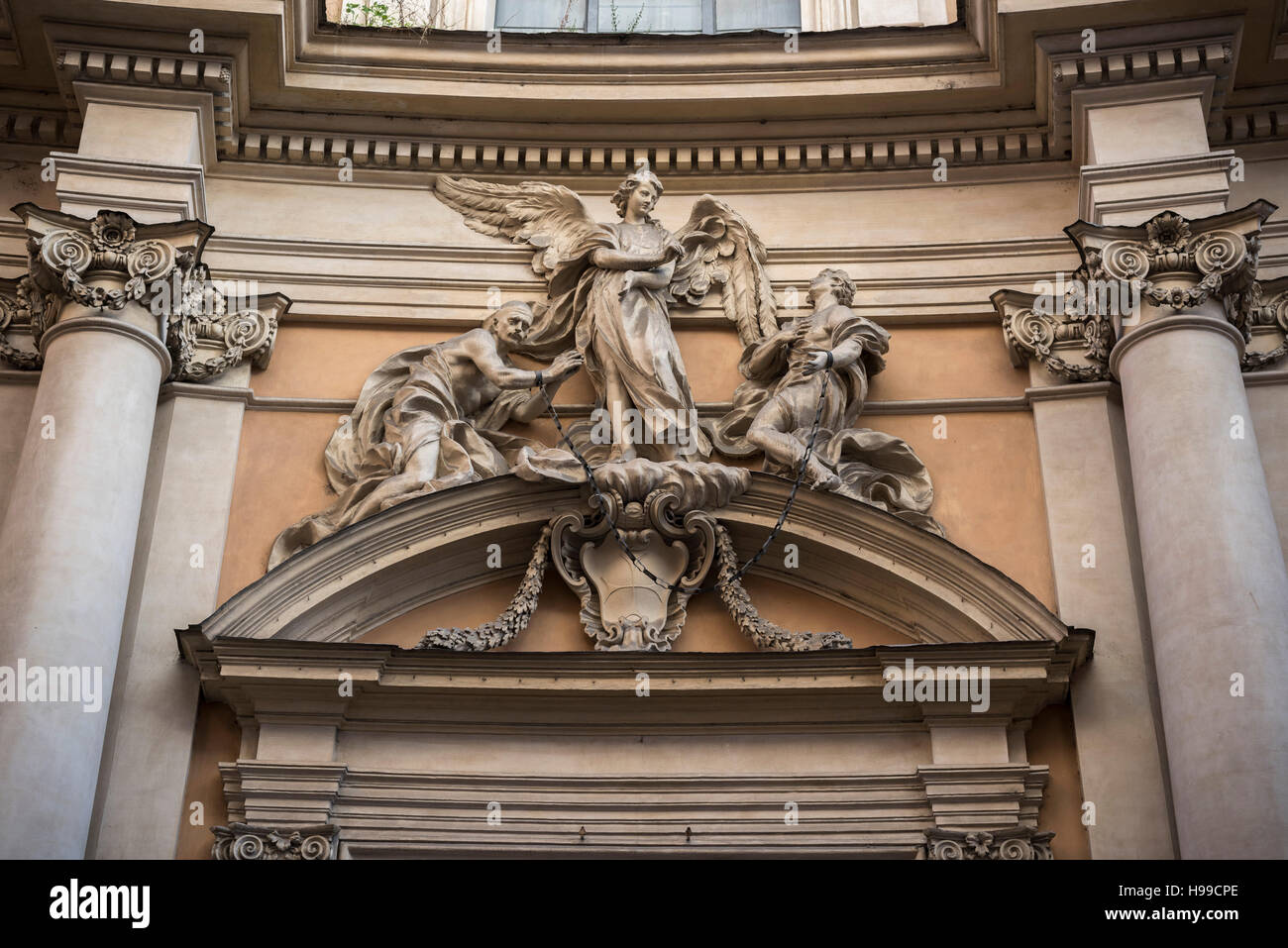 Rome. Italy. Chiesa della Santissima Trinità degli Spagnoli, via dei Condotti. Sculpture of an angel and two slaves. Stock Photo