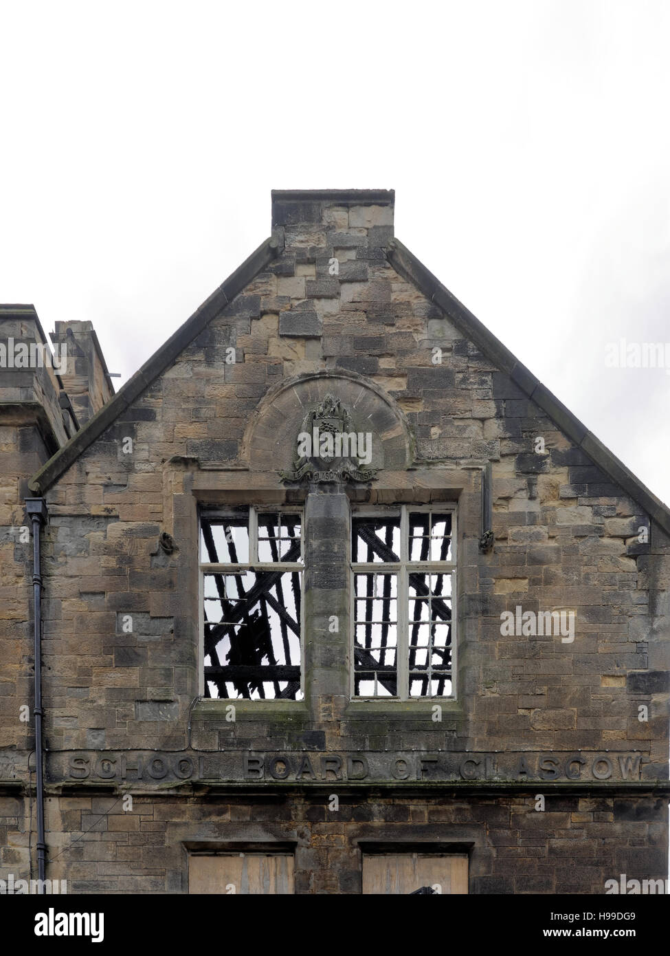 shell of old steiner school Glasgow with roof burnt off windows with Glasgow school sculpted words Stock Photo