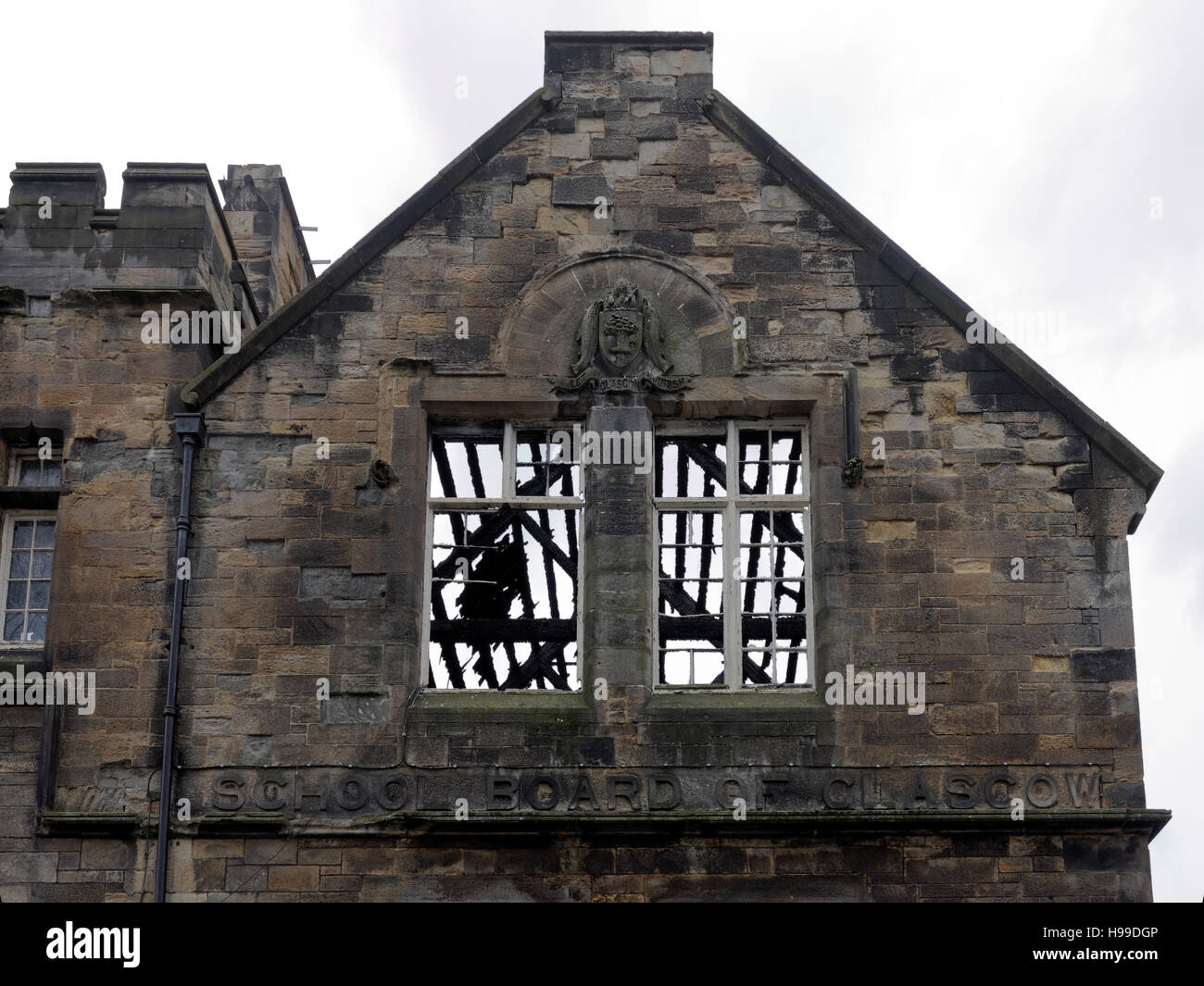 shell of old steiner school Glasgow with roof burnt off windows with Glasgow school sculpted words Stock Photo