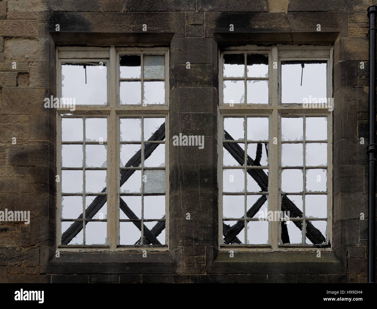 shell of old steiner school Glasgow with roof burnt off windows with Glasgow school sculpted words Stock Photo