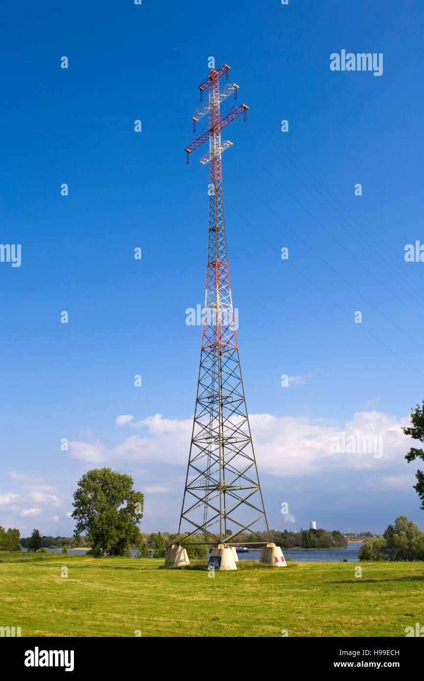 Germany,  Ruhr area, Voerde, 138 meter high pylon of the high voltage power line across the river Rhine in Goetterswickerhamm. Stock Photo