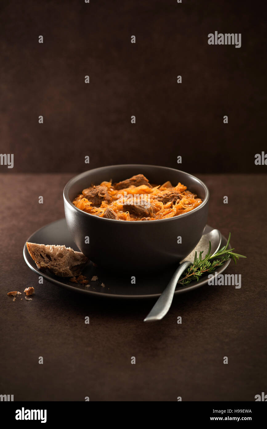Goulash cabbage with beef on dark background. Stock Photo