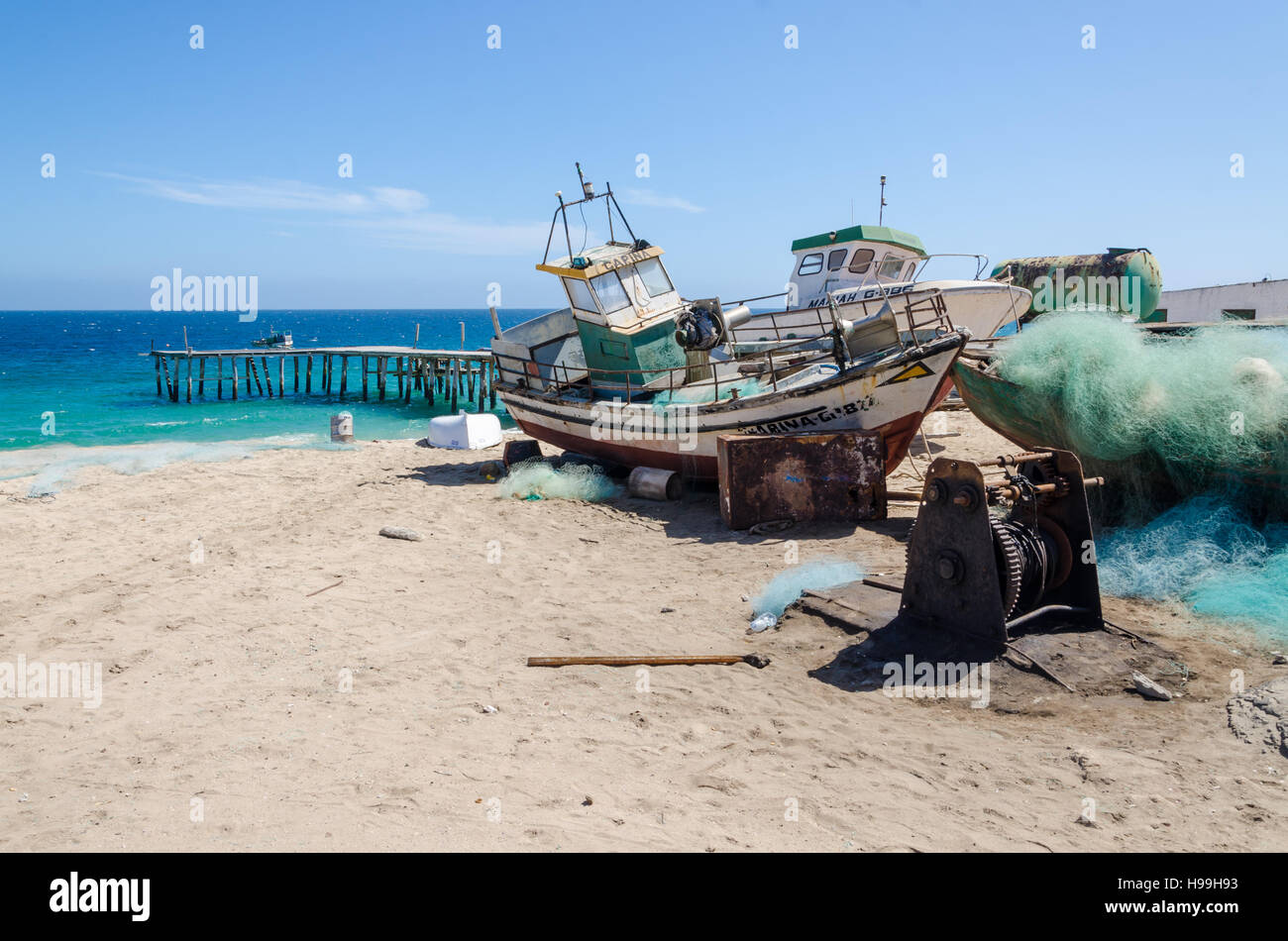 Small fishing boat on the beach hi-res stock photography and