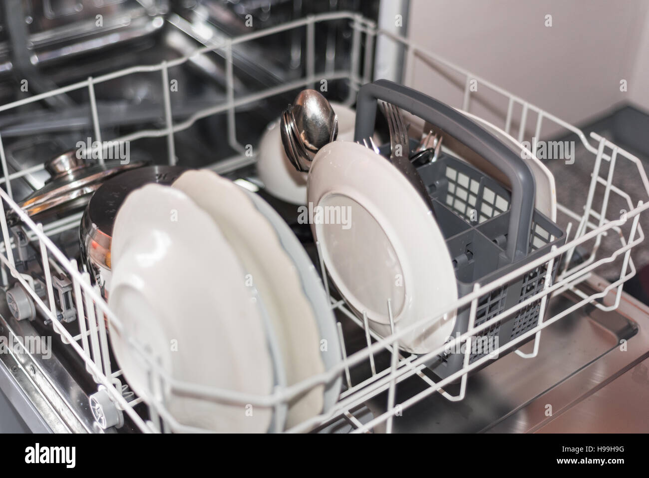 Open dishwasher with clean glass and dishes, selective focus Stock