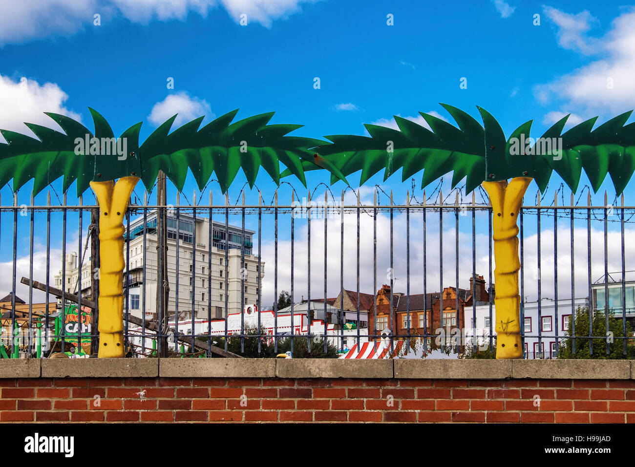Palm trees and barbed wire fence of "Adventure Island" Amusement Park