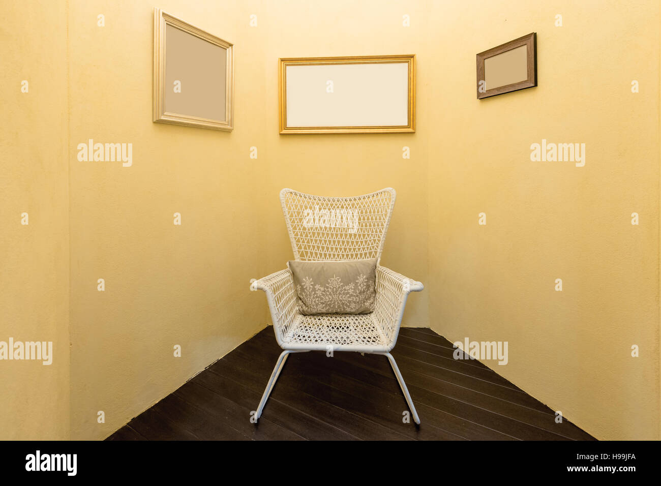 Interior of room with old fashion armchair and picture frame in living room. Yellow color living room. Stock Photo