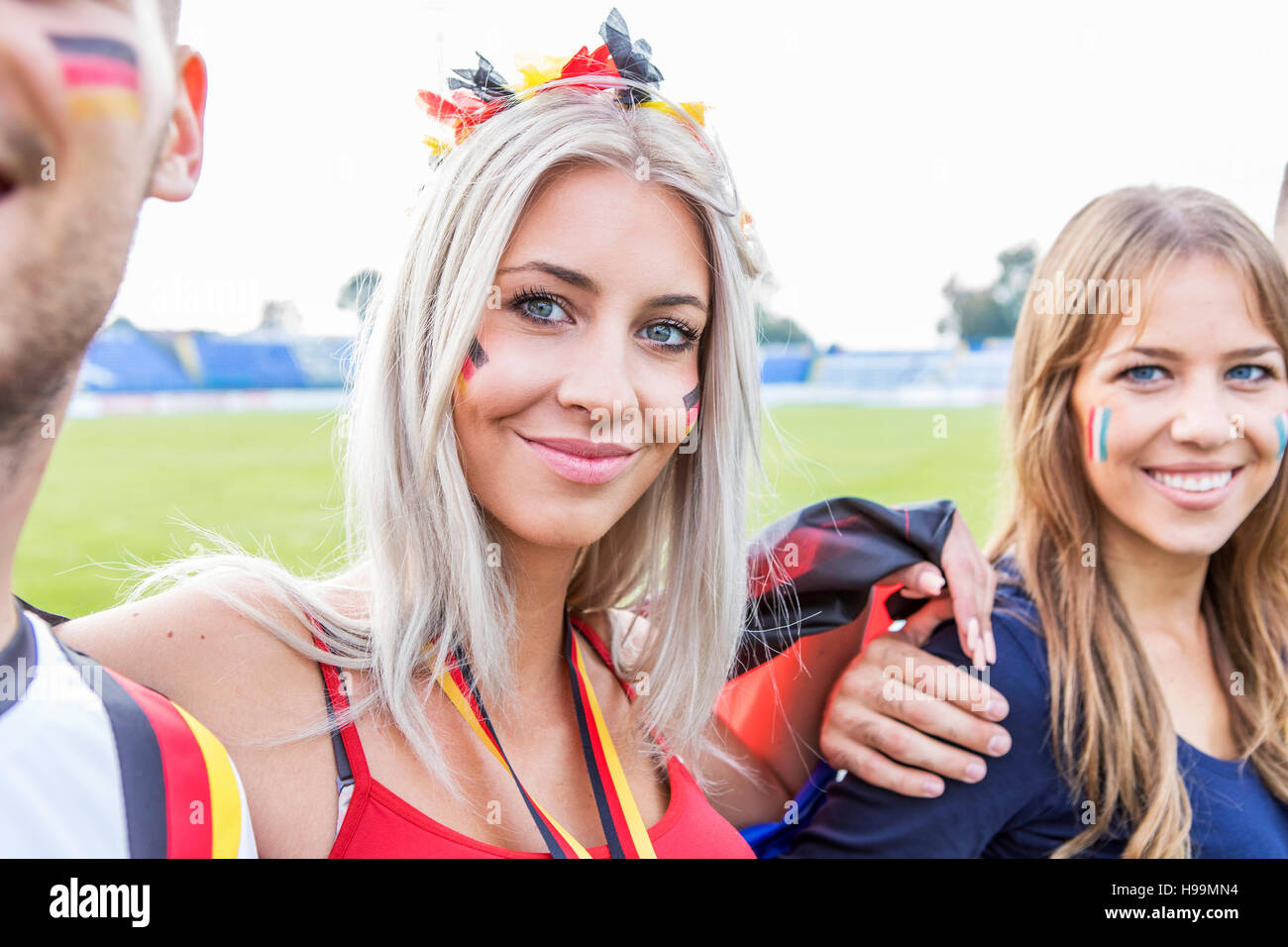 Portrait of soccer fans with face paint Stock Photo