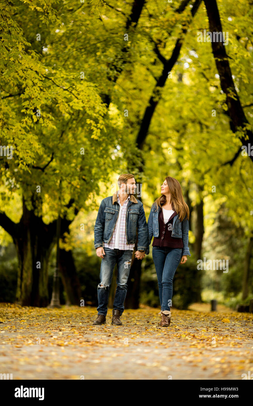 Young loving couple having a walk in the autumn park Stock Photo - Alamy