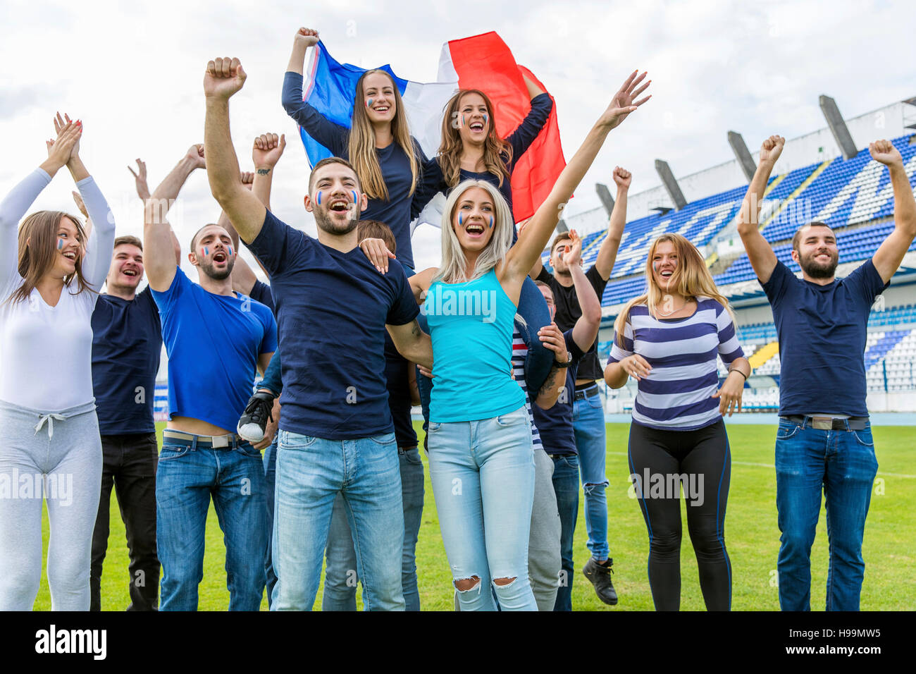 Group of soccer fans celebrating on soccer field Stock Photo Alamy