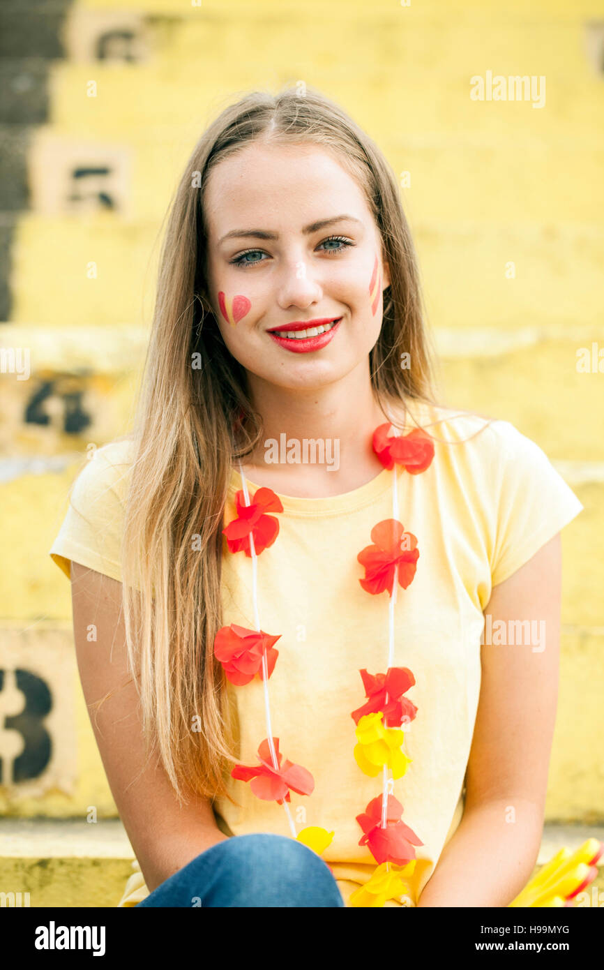 Portrait of female soccer fan with floral garland Stock Photo