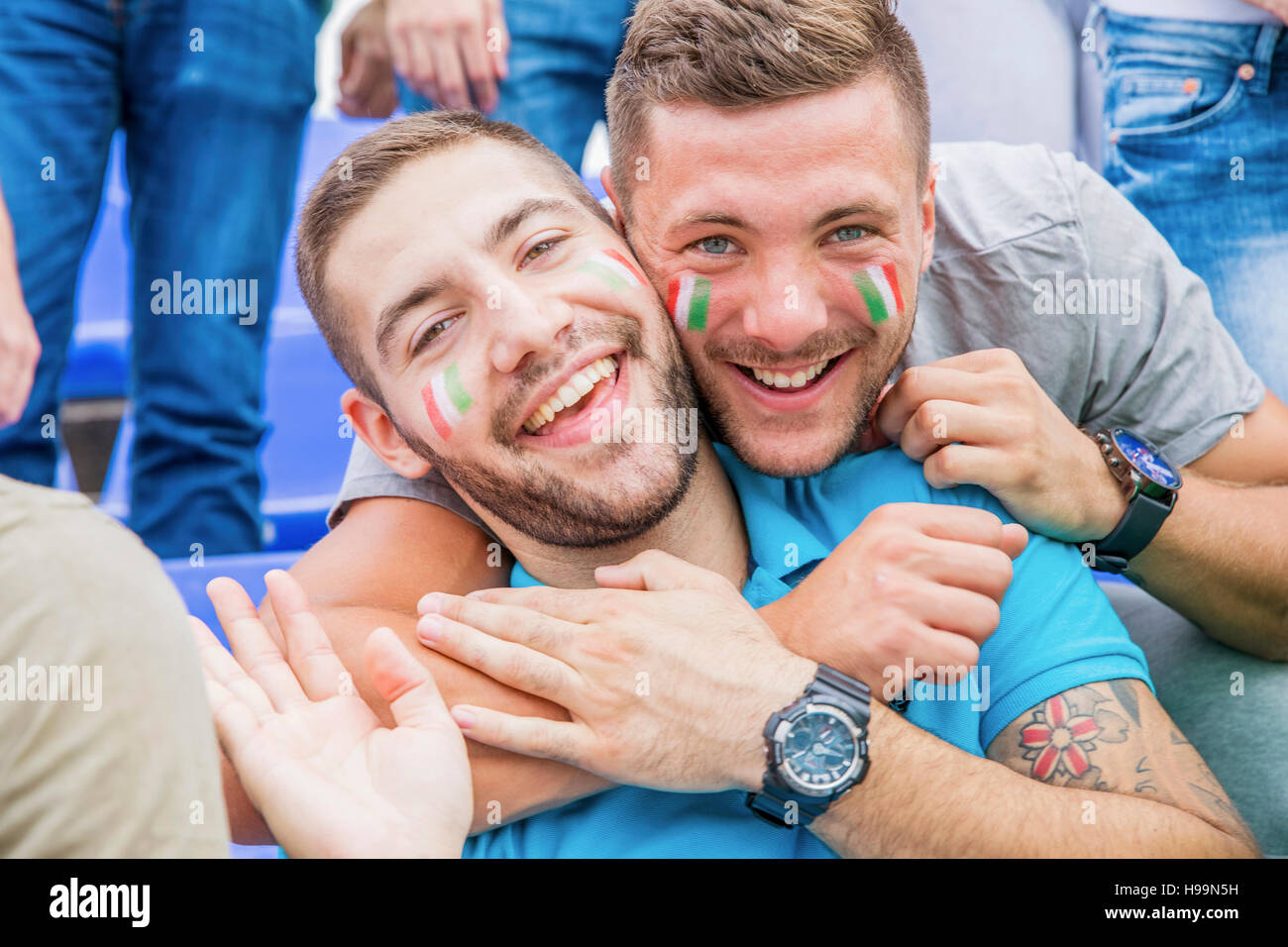 Two soccer fans with face paint in Italian colors Stock Photo