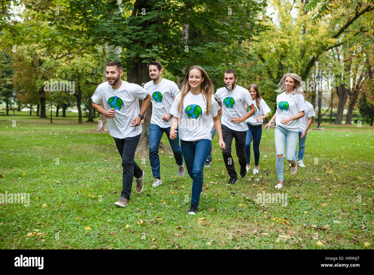 Teenage volunteers doing garbage cleanup in park Stock Photo