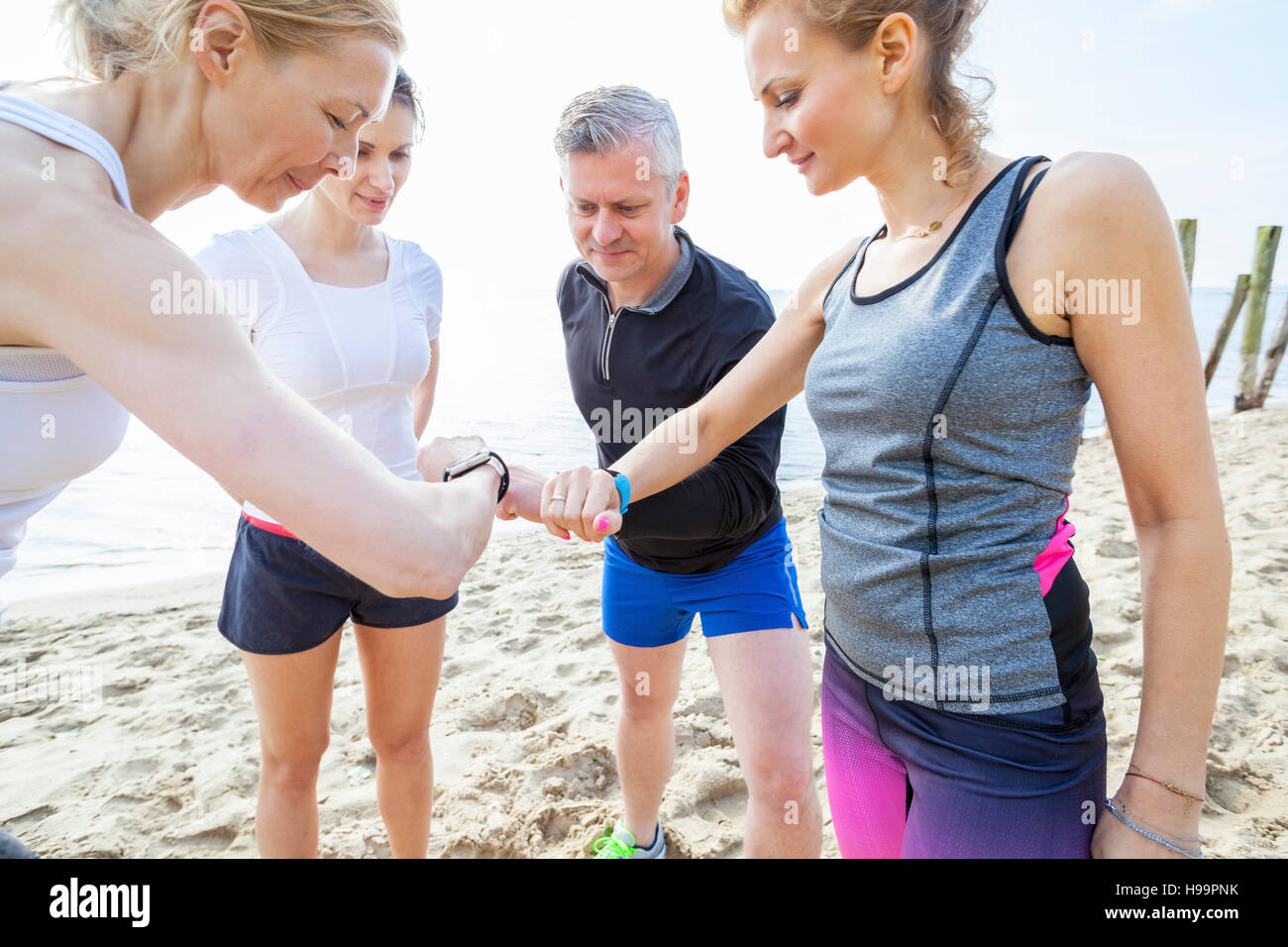 Group of friends checking their running watches Stock Photo