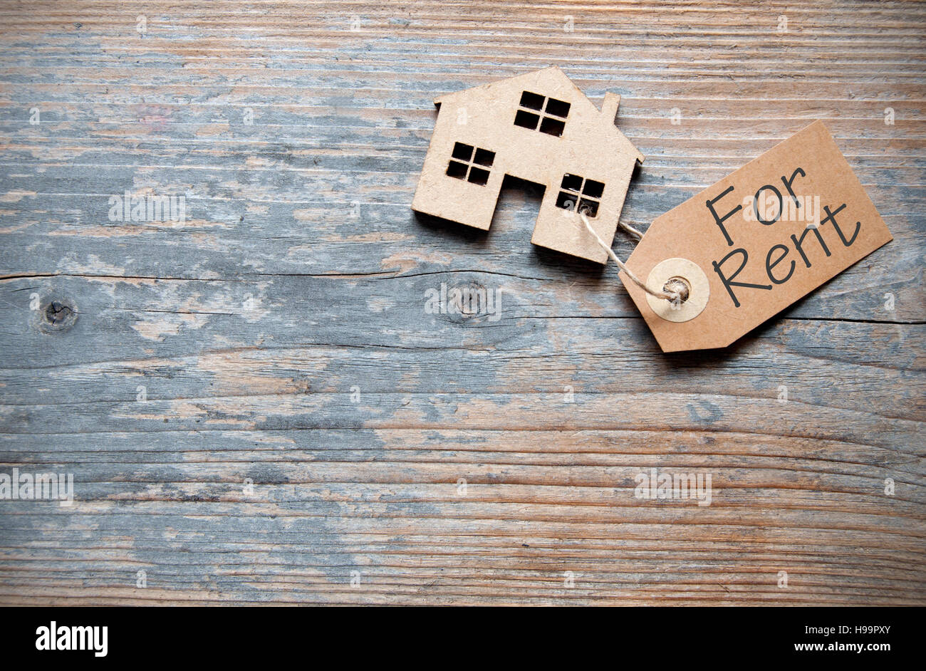 House For Rent Label Small house with rental label over a wooden background with space Stock ...