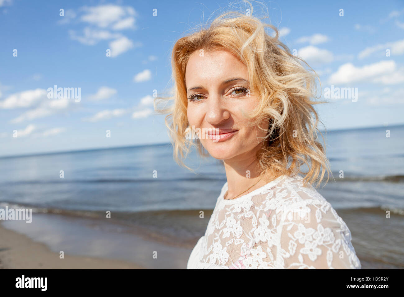 Portrait of woman with blond hair on beach Stock Photo - Alamy