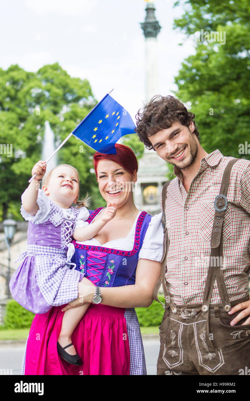 Parents and daughter waving European flag Stock Photo