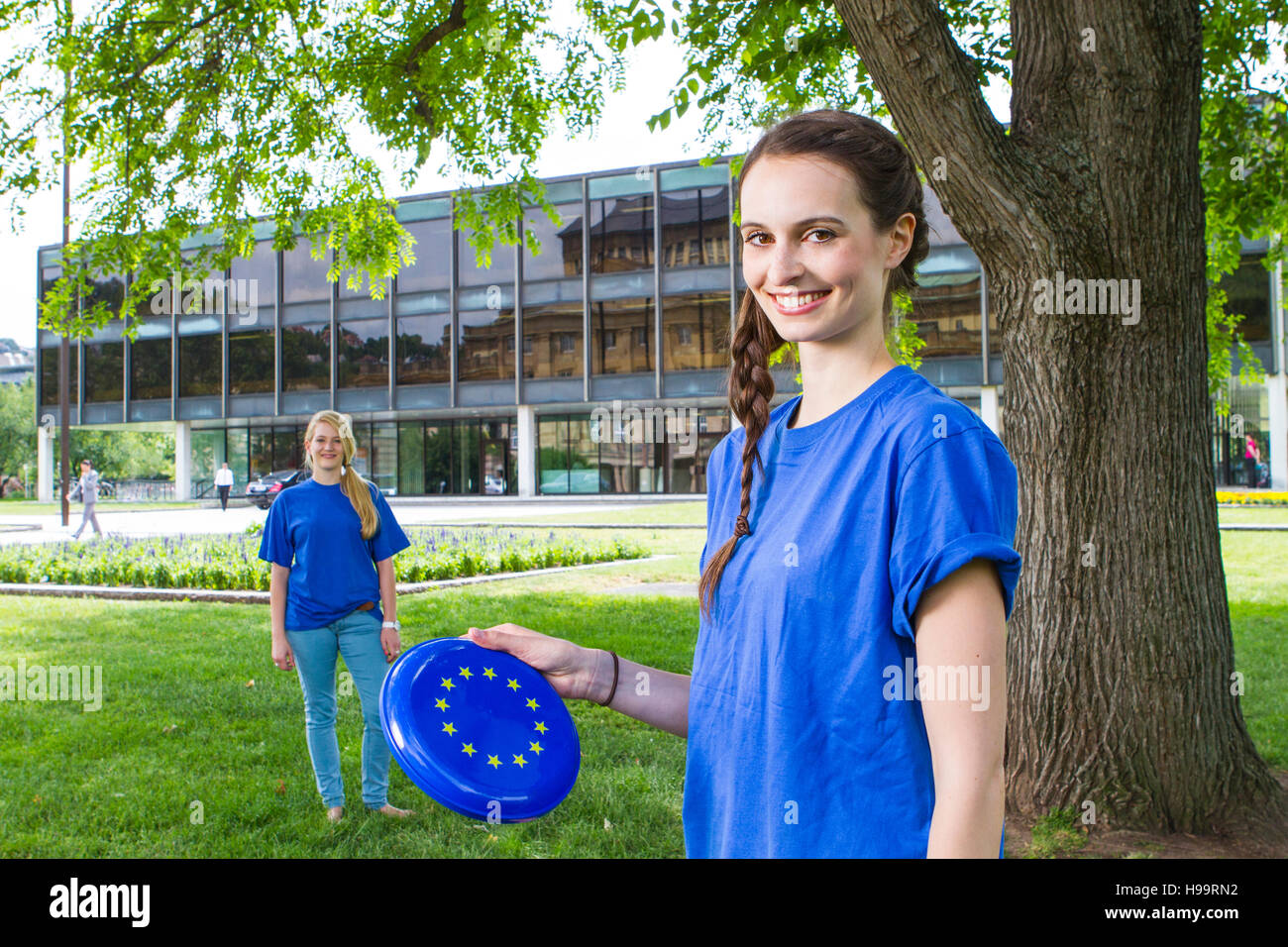 Young woman playing with plastic disc with European logo Stock Photo