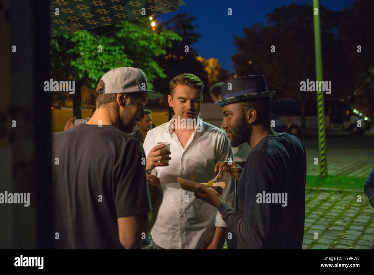 Group of customers at food truck drinking and eating Stock Photo