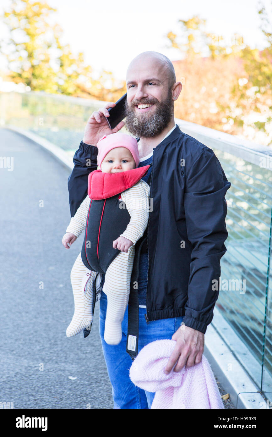Father with baby girl in baby carrier Stock Photo