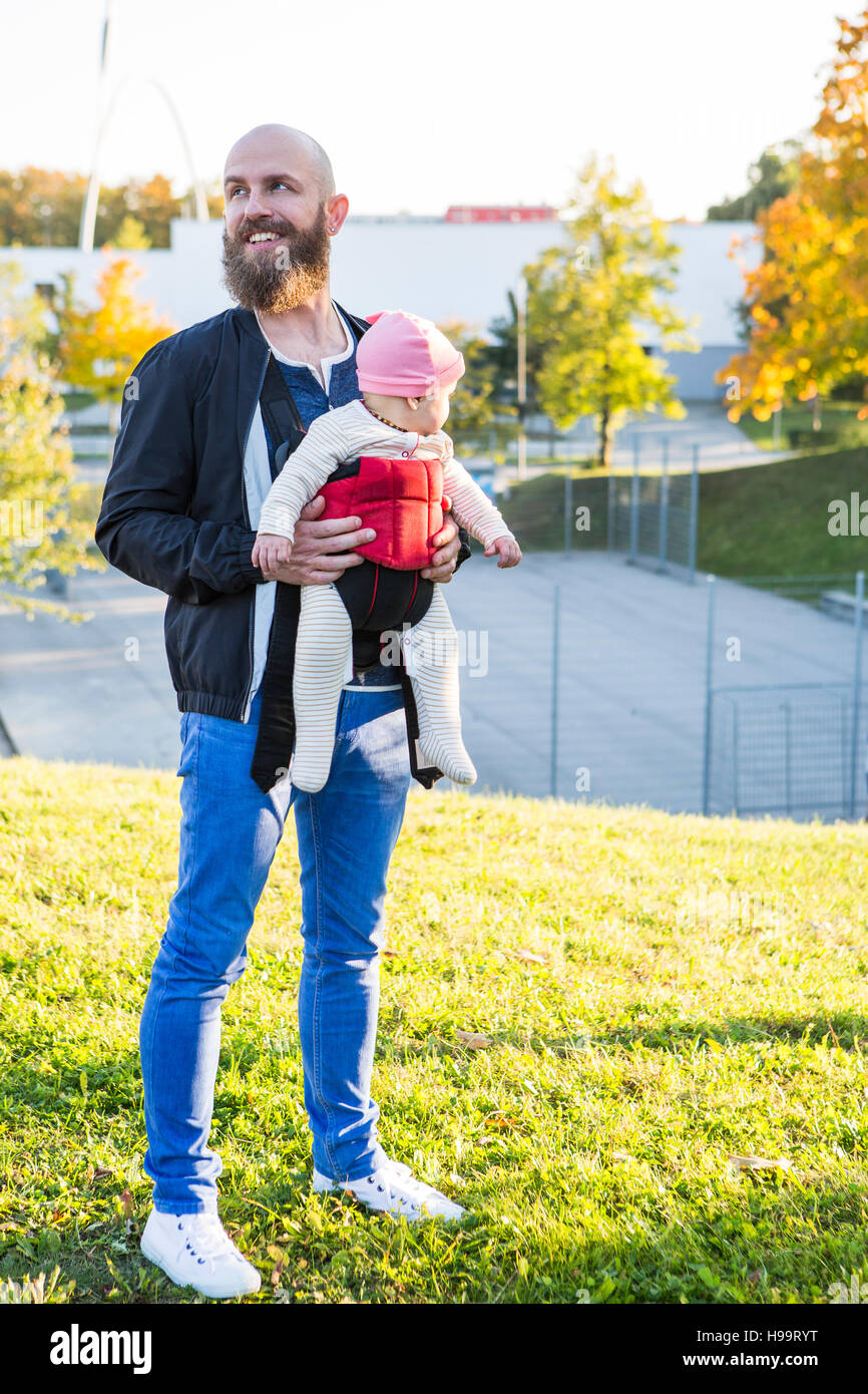 Father With Baby Girl In Baby Carrier Standing In Park Stock Photo Alamy