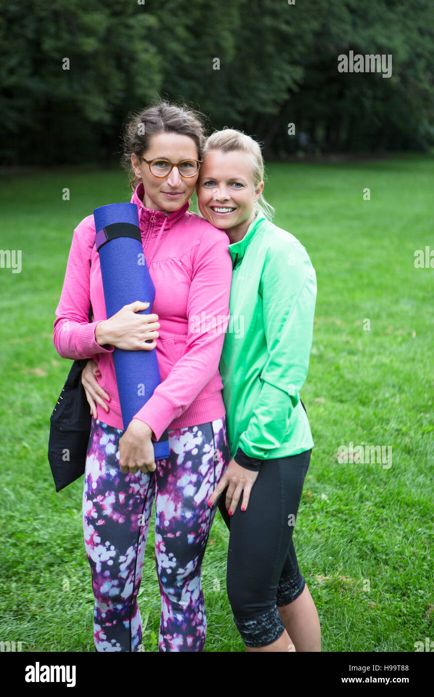 Two young women in sports clothing in park Stock Photo