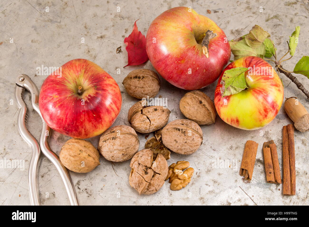 Apples, walnuts and nuts cracker on a table Stock Photo