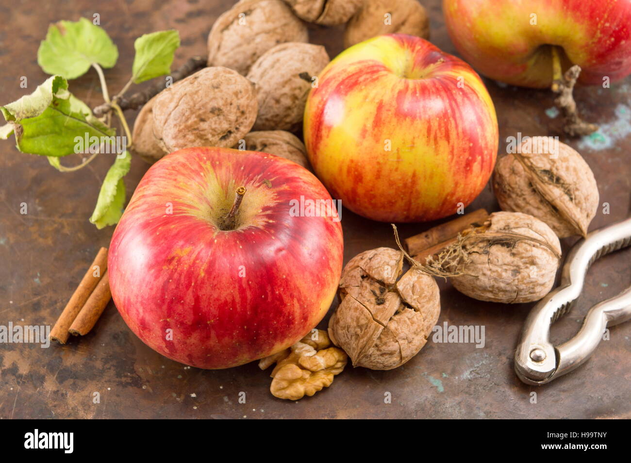 Apples, walnuts and nuts cracker on a table Stock Photo
