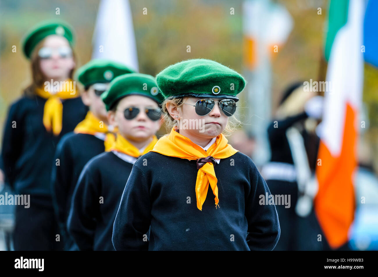 Belfast, Northern Ireland. 13 Nov 2016 - Children dressed in pseudo-paramilitary uniforms including green berets, orange neck scarfs, white shirts, black jumpers and wearing mirrored sunglasses take part in an Irish Republican Parade. Stock Photo