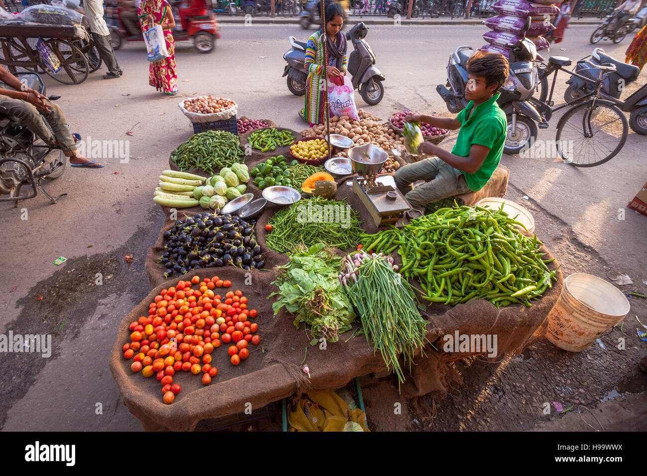 Street market stall selling fresh vegetables tomatoes, chillies, in